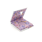 Pink makeup compact with starfish design on a white background