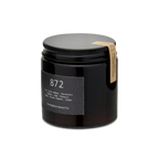 Candle in a black jar with a label on a white background
