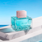 Blue perfume bottle on a marble surface with a blue background