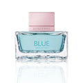 Thick glass perfume bottle with blue juice and rose cap on a white background