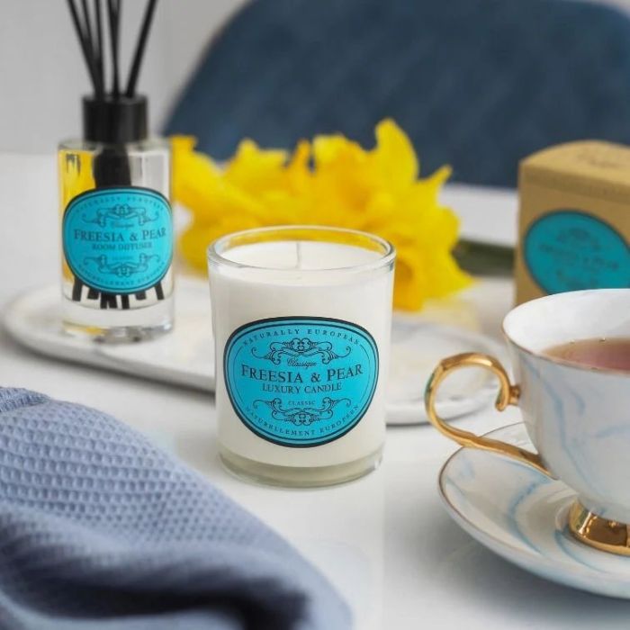 Somerset Toiletry Company Freesia and Pear scented candle in an elegant glass jar—luxurious floral home fragrance with notes of freesia and ripe pear, offering up to 40 hours of burn time (200g).