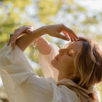 Woman in a white dress with a blurred natural background