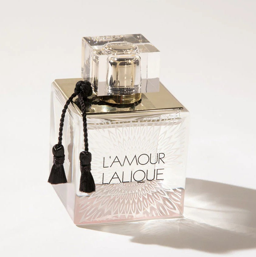 Lalique perfume bottle with 'L'Amour Lalique' text on a white background