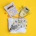 Cosmetic pouch with animal print and 'TOOT!' branding on a yellow background