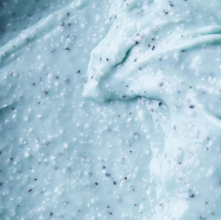 “Close-up of Tuttotondo Mirto exfoliating cream texture showing creamy base with natural myrtle and exfoliating granules for smooth skin