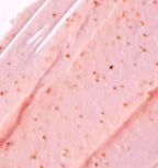 Close‑up of Fico d’India exfoliating cream texture — rosy‑pink cream with natural prickly‑pear and kiwi‑seed exfoliating particles for smooth skin