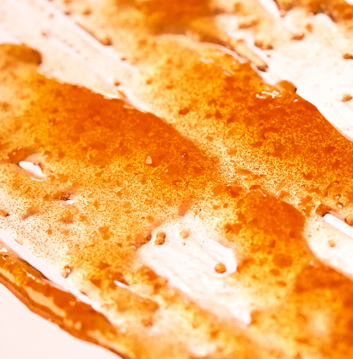 Close-up of a textured orange surface with white patches