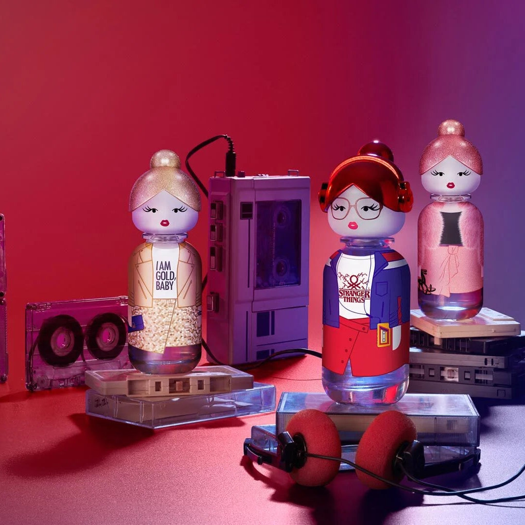 Vintage-style toys and audio equipment on a red background with benetton sisterland bottles