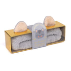 Cat-shaped towel set with gold packaging on a white background