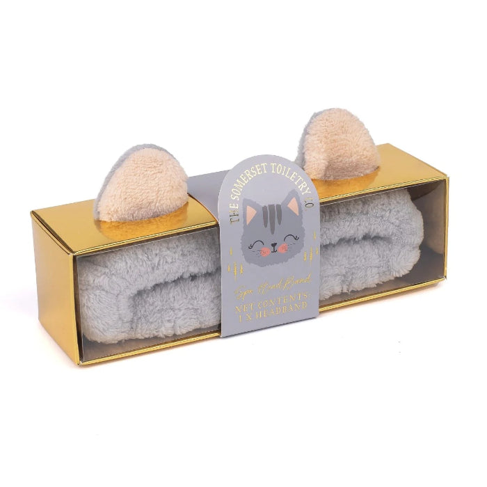 Cat-shaped towel set with gold packaging on a white background
