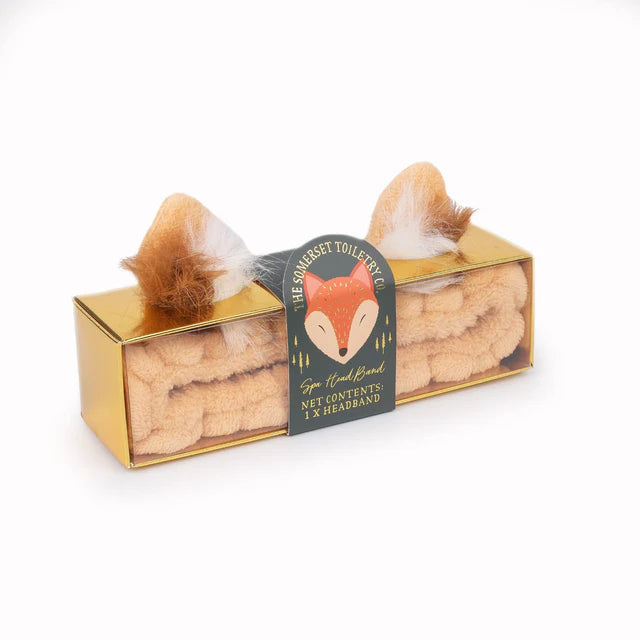 Gold box with a fox shaped headband and a fox-themed label on a white background